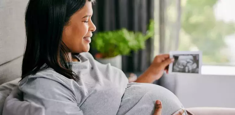 Pregnant woman holding an ultrasound