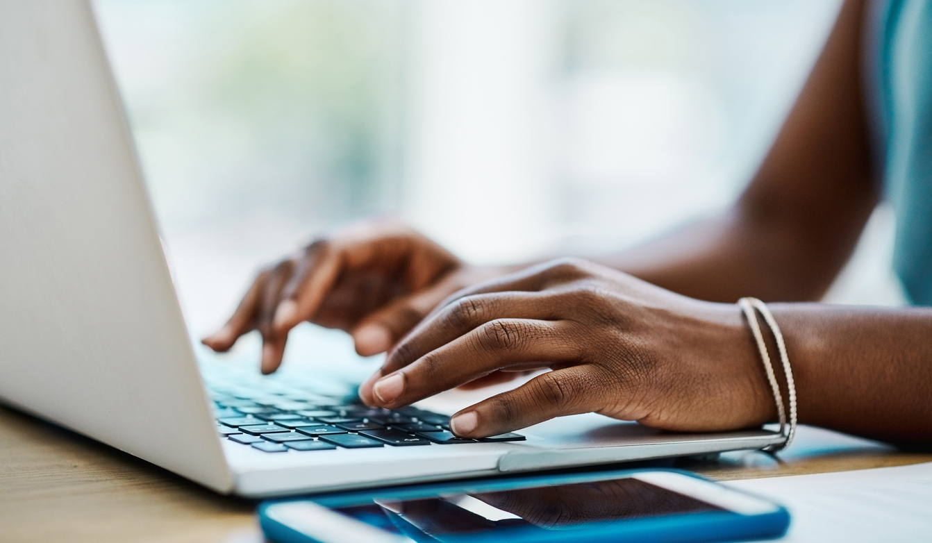 Close up of a woman using a laptop