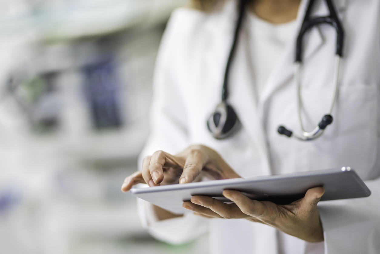 A doctor using a tablet