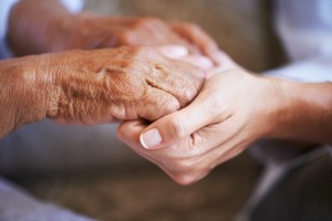 Older hands holding younger hands