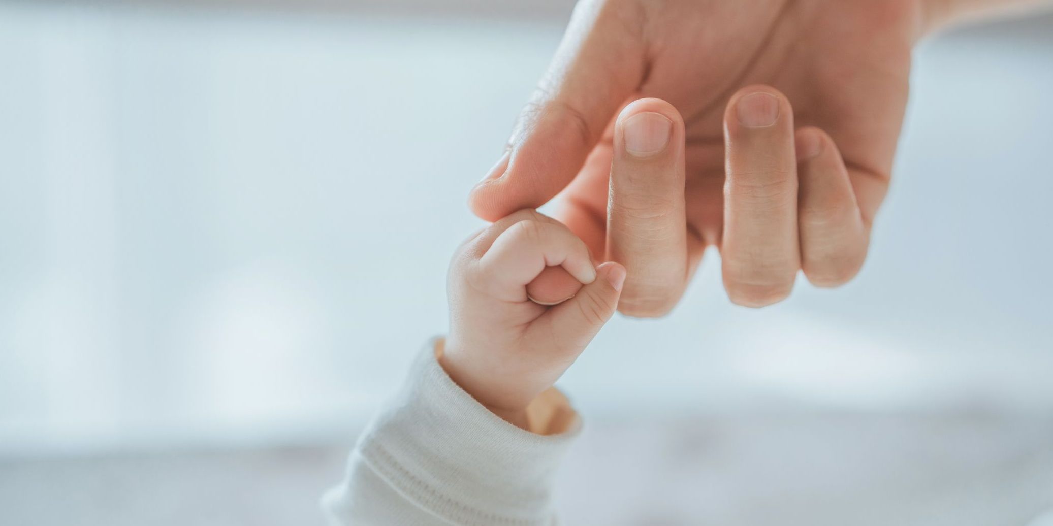 Close-up little hand of child baby holding hand of mother