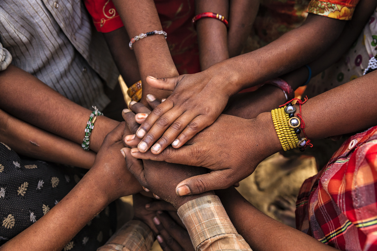 A group of people with their hands in the centre