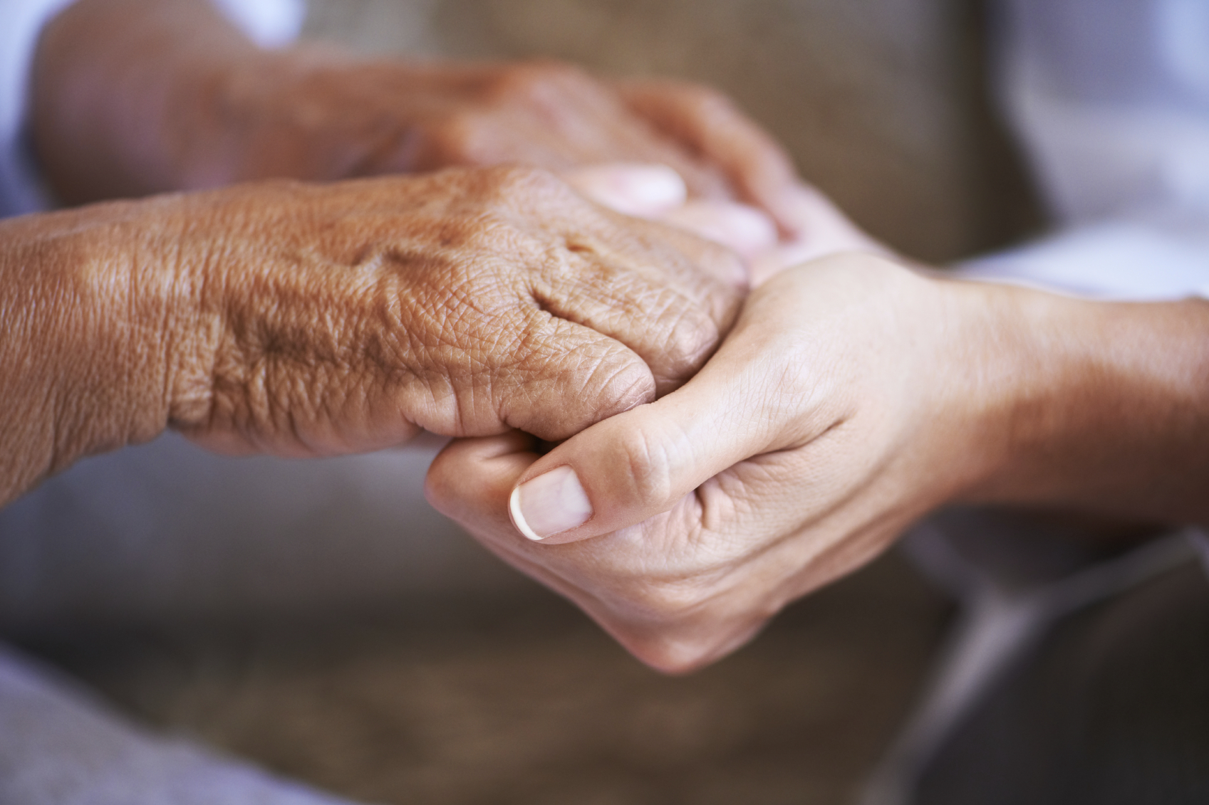 Older hands holding younger hands
