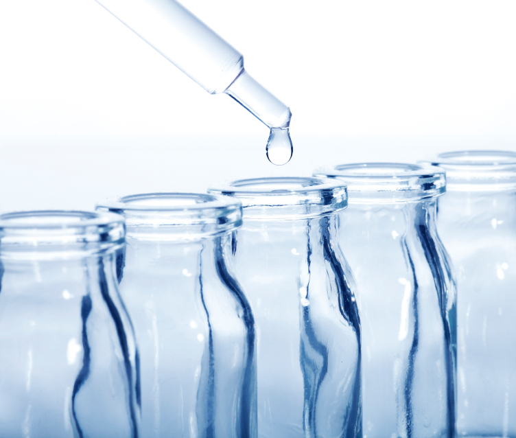 pipette dropping liquid into bottles