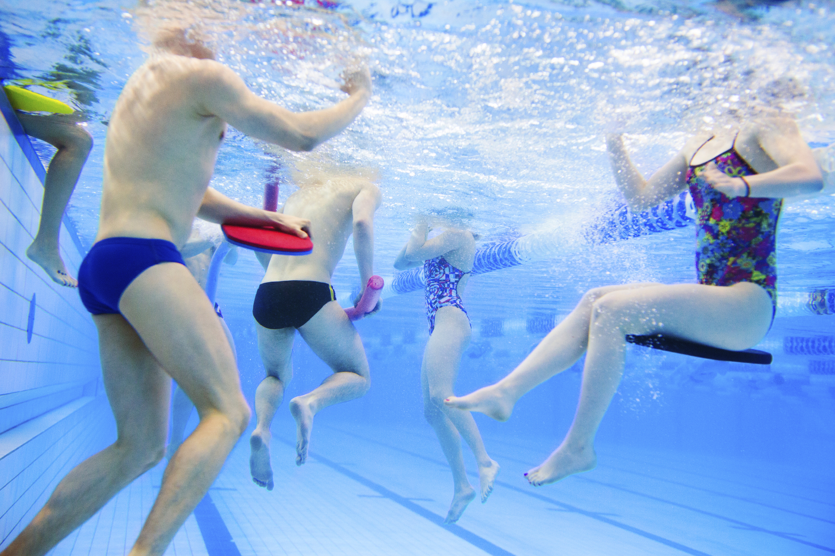 children swimming in a swimming pool