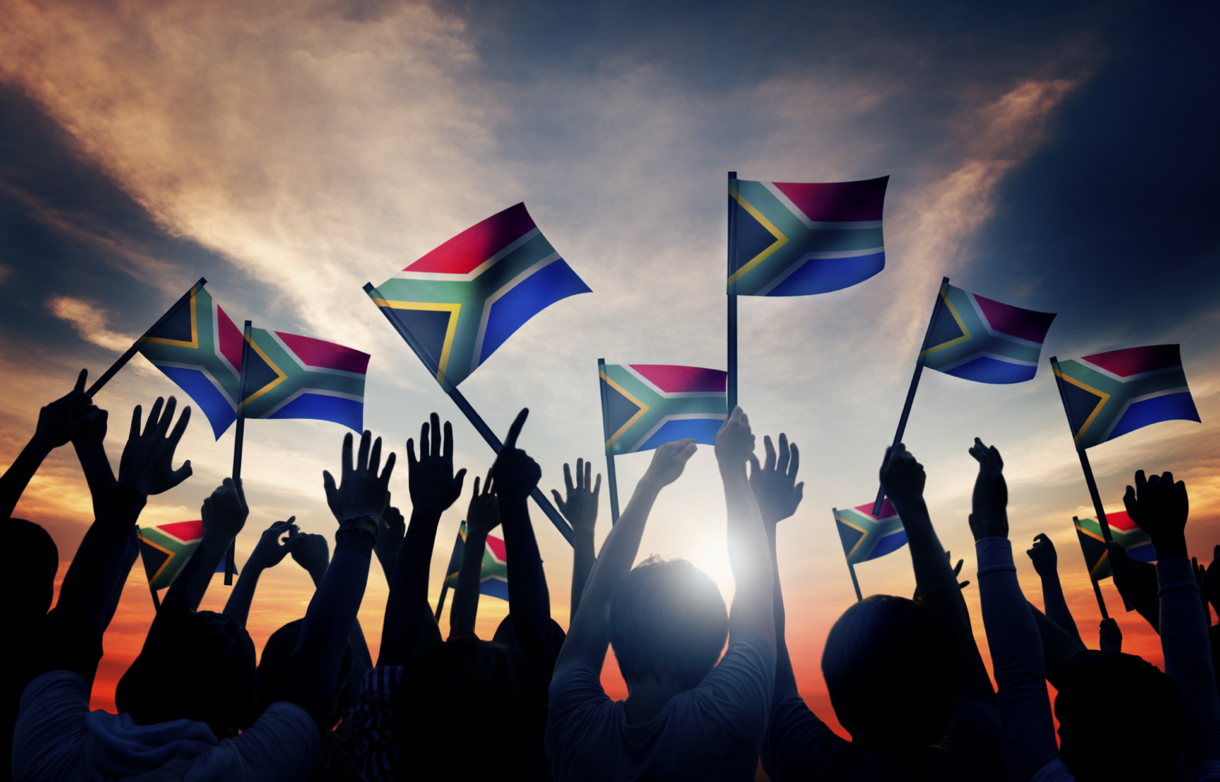 A group of people waving the South African flag