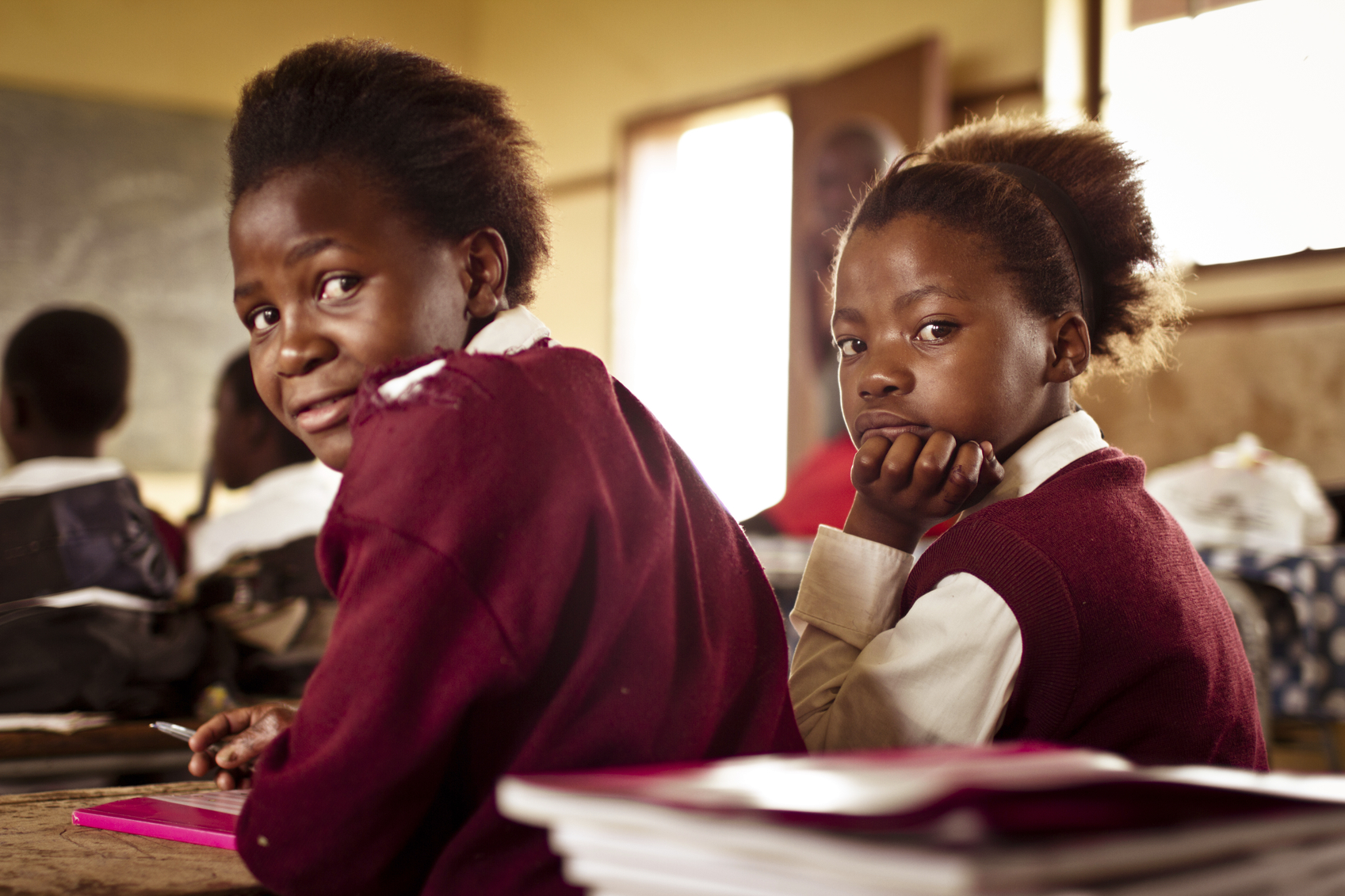 Two children sat at desk in school