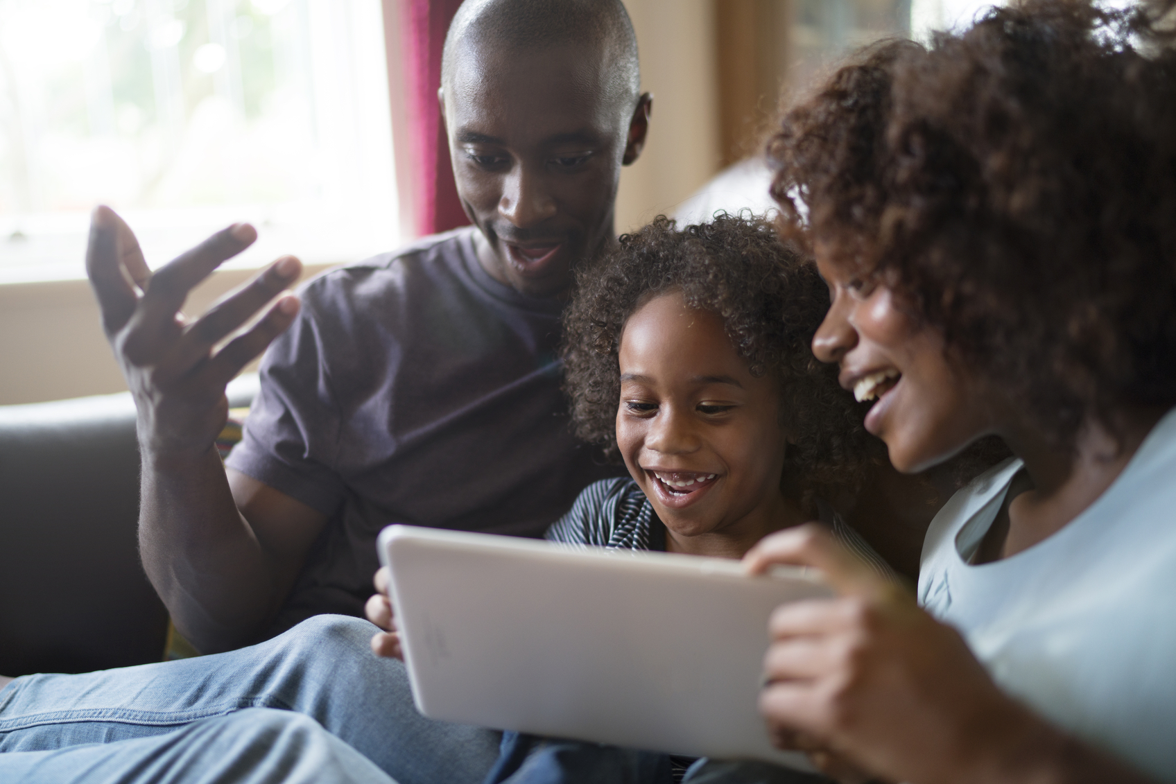 A family looking at a digital tablet