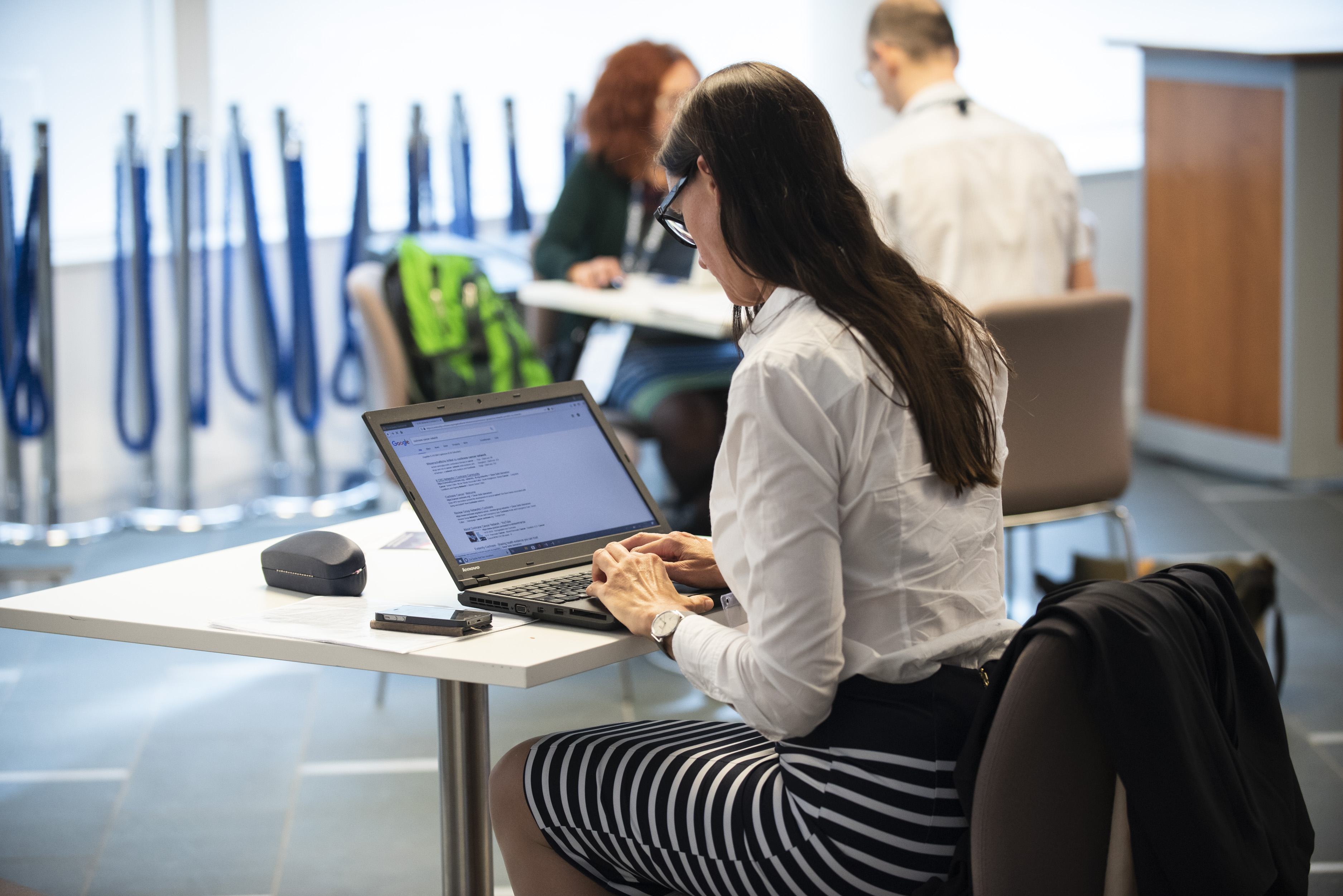 Woman working at a laptop in an office